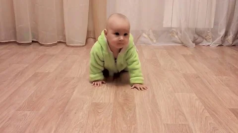 Small child crawls on the floor Stock Footage 83877776