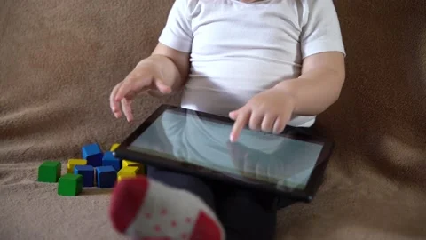 A small child does not want to play with a tablet computer Stock Footage 237607786