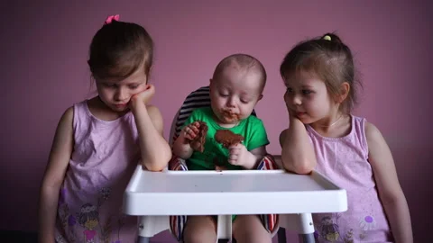 A small child eats chocolate. His face and hands are very dirty. The kid is Stock Footage 169158745
