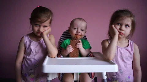 A small child eats chocolate. His face and hands are very dirty. The kid is Stock Footage 169158924