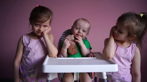 A small child eats chocolate. His face and hands are very dirty. The kid is Stock Footage 169159332