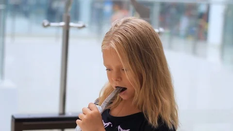 A small child eats a delicious, sweet candy Stock Footage 113522261