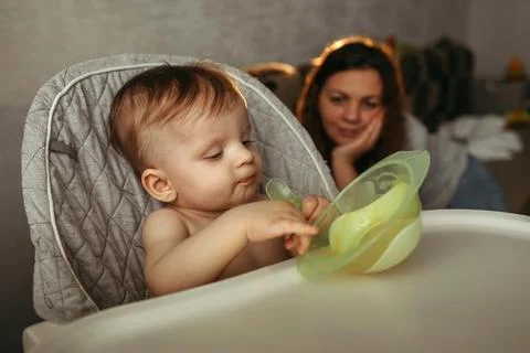 A small child eats vegetable puree. Stock Photos