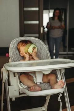 A small child eats vegetable puree without a spoon Stock Photos