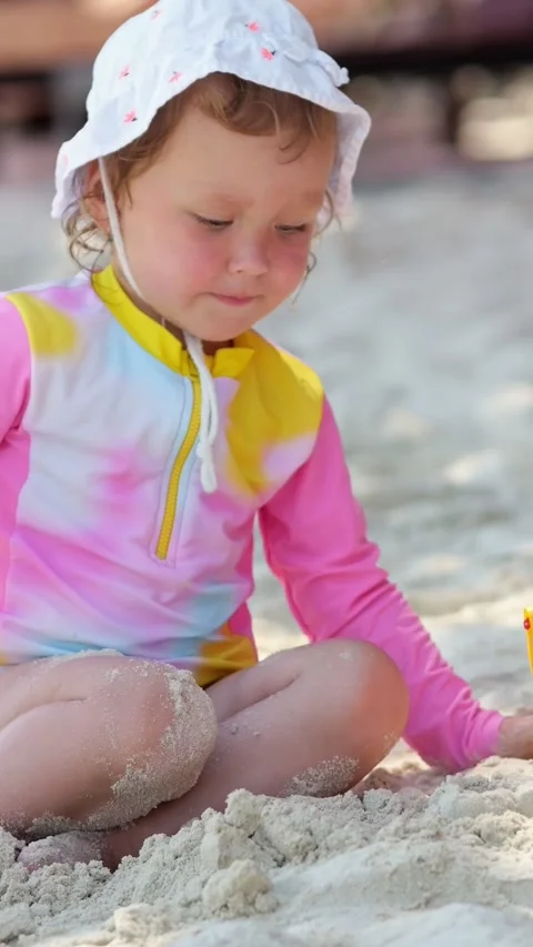 Small Child Engaged With Sandy Toys Under Sunhats. Child Discovering Creative 스톡 동영상 332644902