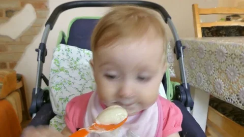 A small child is fed from a spoon Stock Footage 82371119