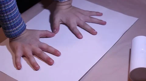 A Small Child of Five Years Puts Two Hands on a White Sheet of Paper. Boy Bangs Stock Footage 68826948