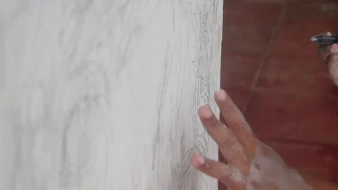 A small child hand is scribbling on a white wall with a crayon. Video stock 327731315