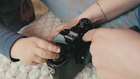 Small Child Hand Turning Dial on Vintage Camera in Leather Case Stock Footage 334117243