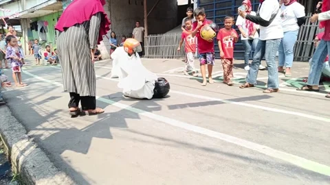 A small child is having a sack race to celebrate Indonesia's independence day Stock Footage 248230910
