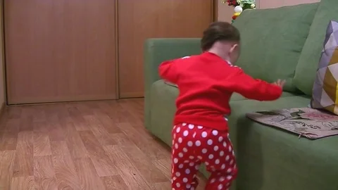 A small child himself climbs onto a sofa and goes to bed Stock Footage 89571127