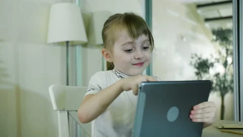 Small Child Hold Pad Computer Surfing Internet Play Game At Home Alone Stock Footage 154684041