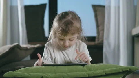 Small Child Hold Pad Computer Surfing Internet Play Game At Home Alone Stock Footage 225234254