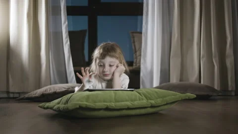 Small Child Hold Pad Computer Surfing Internet Play Game At Home Alone Video stock 235301117