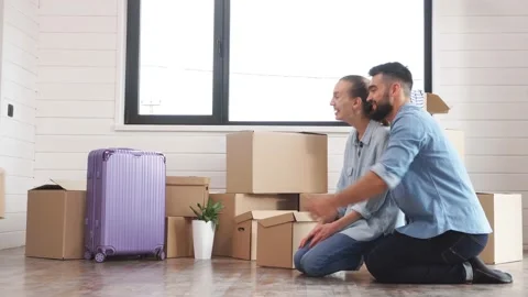 Small child is holding a small box. Parents are waiting for a child with a box. Stock Footage 117129470