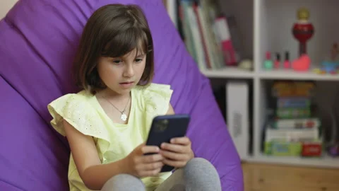 Small child learning in cellphone, watching video, having fun with mobile Stock Footage 194748000