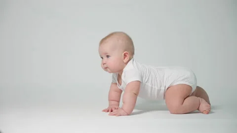 A small child learning to crawl , the concept of child development and health Stock Footage 235597397