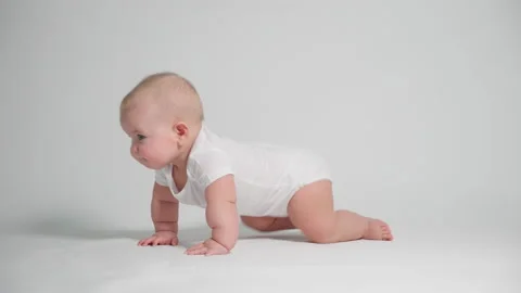 A small child learning to crawl , the concept of child development and health Stock-Footage 235597535
