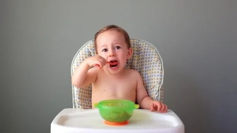 Small Child learning to eat Stock Footage 69196484
