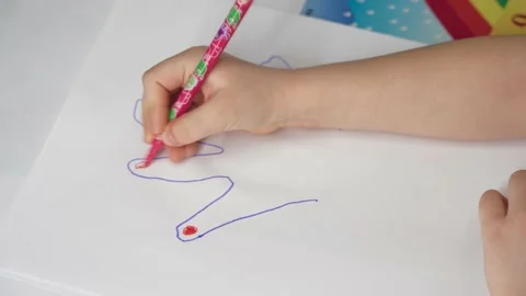 A small child learns to draw. draws a hand with a blue felt-tip pen. close - up Stock Footage 235297779