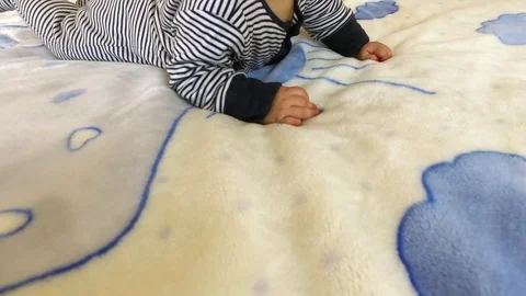 A small child lies on a bed Video stock 81883394