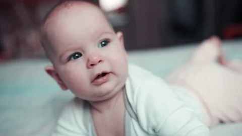 A small child looks at something and smiles Stock-Footage 85219416