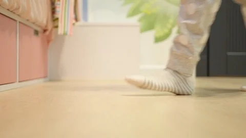 A small child opens a box in bed in a nursery Stock Footage 101547421