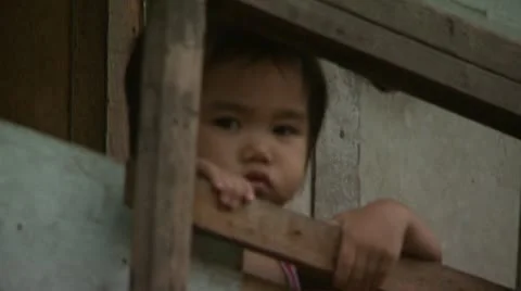 Small Child Peers Through Railing in Squatter Neighborhood Stock Footage 11495266