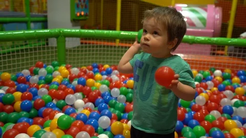 A small child picks up the balls Stock Footage 104028371