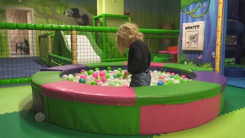 Small child playing in ball pit Stock Footage 123430517