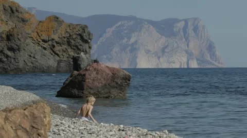 A small child playing on the beach. Stock Footage 22156659