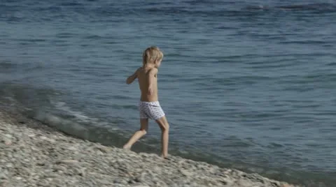 A small child playing on the beach. Stock Footage 22156688