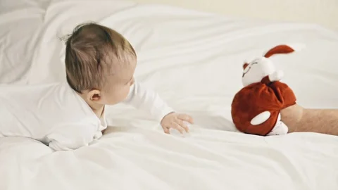 A small child playing Stockbeeldmateriaal 70604017