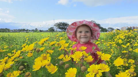 Small child playing in a meadow full of flowers. Spain.  Clip 1. Stock Footage 44561270