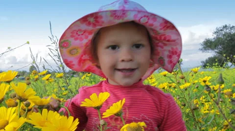 Small child playing in a meadow full of flowers. Stock Footage 44561340