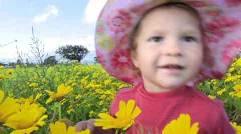 Small child playing in a meadow full of flowers. Mar Menor. Spain.  Clip 5. Stock Footage 44561371