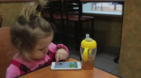 Small child playing with the phone Stock Footage 56529814