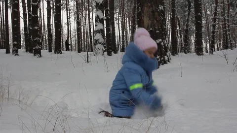 Small child playing in the snow Stock Footage 70284001