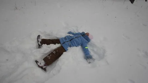 Small child playing in the snow Stock Footage 70284100