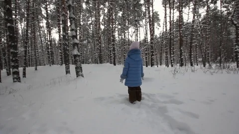 Small child playing in the snow Stock Footage 70284220