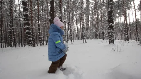 Small child playing in the snow Stock Footage 70284306