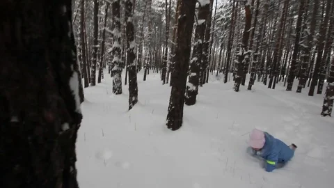 Small child playing in the snow Stock Footage 70286193