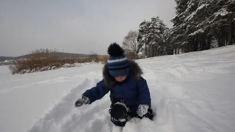 Small child playing in the snow Stock-Footage 70288842