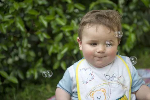Small child playing with soap bubbles Stock Photos