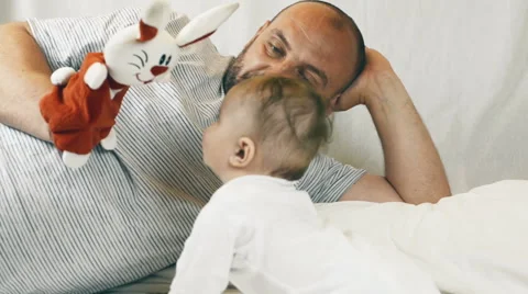 A small child playing successfully caught the rabbit, video Stockbeeldmateriaal 63764728