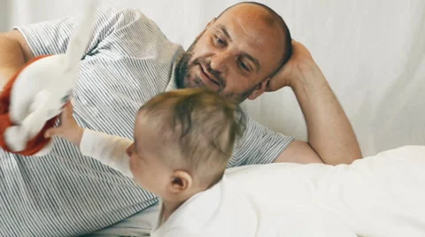 A small child playing successfully caught the rabbit, video Stockbeeldmateriaal 64586272