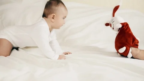 A small child playing successfully caught the rabbit Stockbeeldmateriaal 74351384