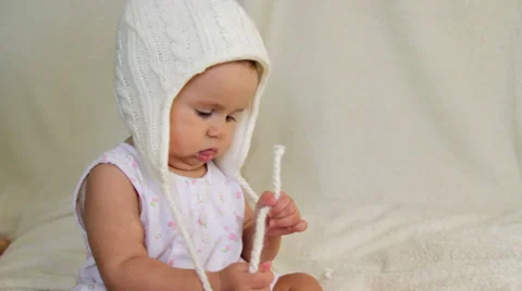 Small child playing with warm hat Stock Footage 32714598