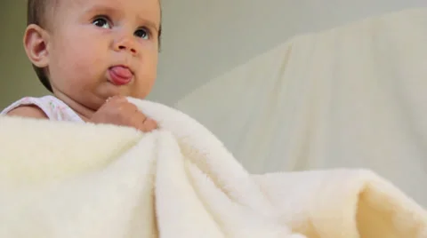 Small child plays with a blanket Stock Footage 32714907