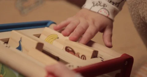 Small child plays a child's developing tactile game close-up Video stock 88973413